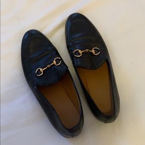Black loafers with golden bit buckle